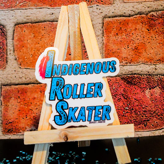 Sticker with 'Indigenous Roller Skater' text on a wooden stand against a brick wall.