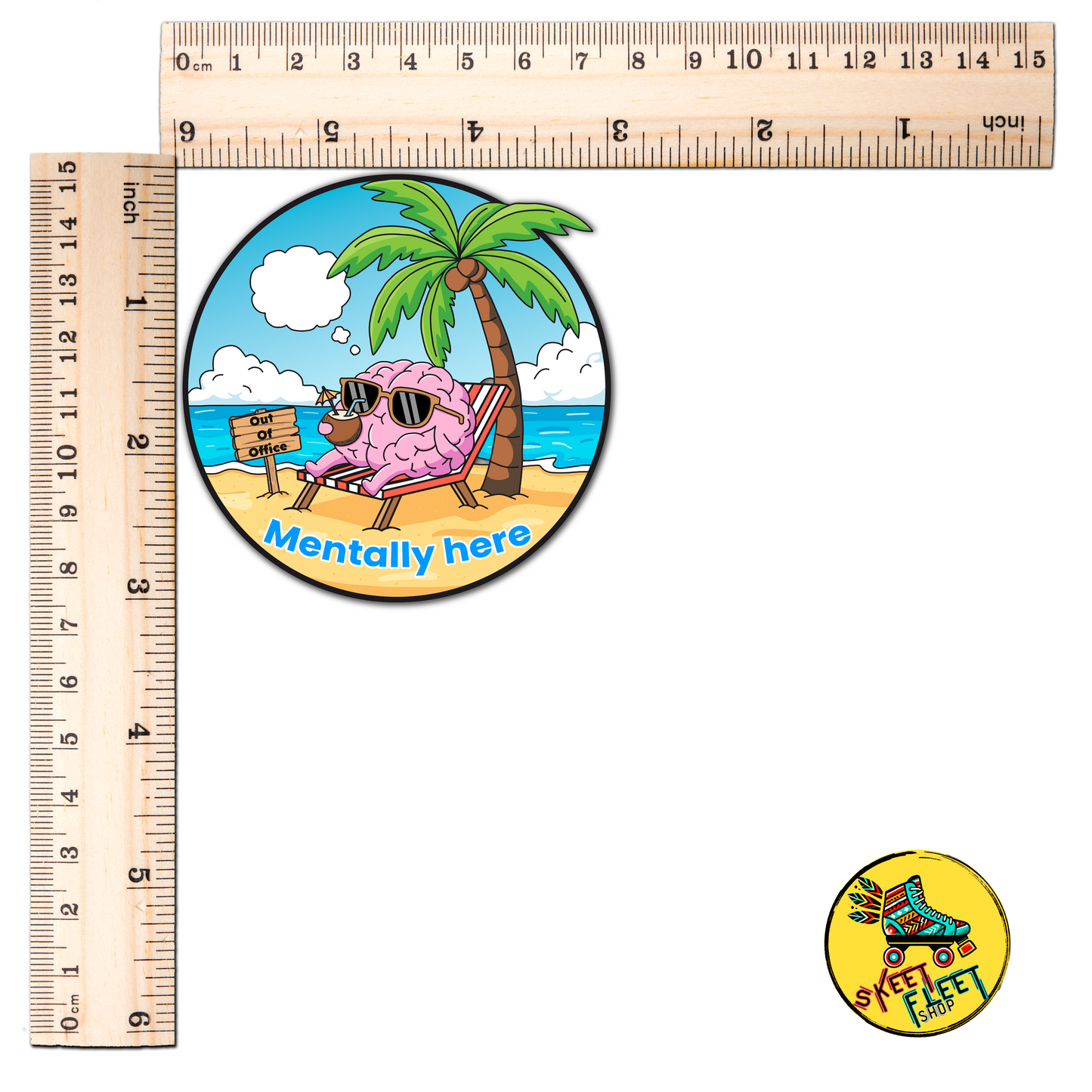 Circular sticker with brain character on a beach, ruler for scale, and smaller sticker with text.