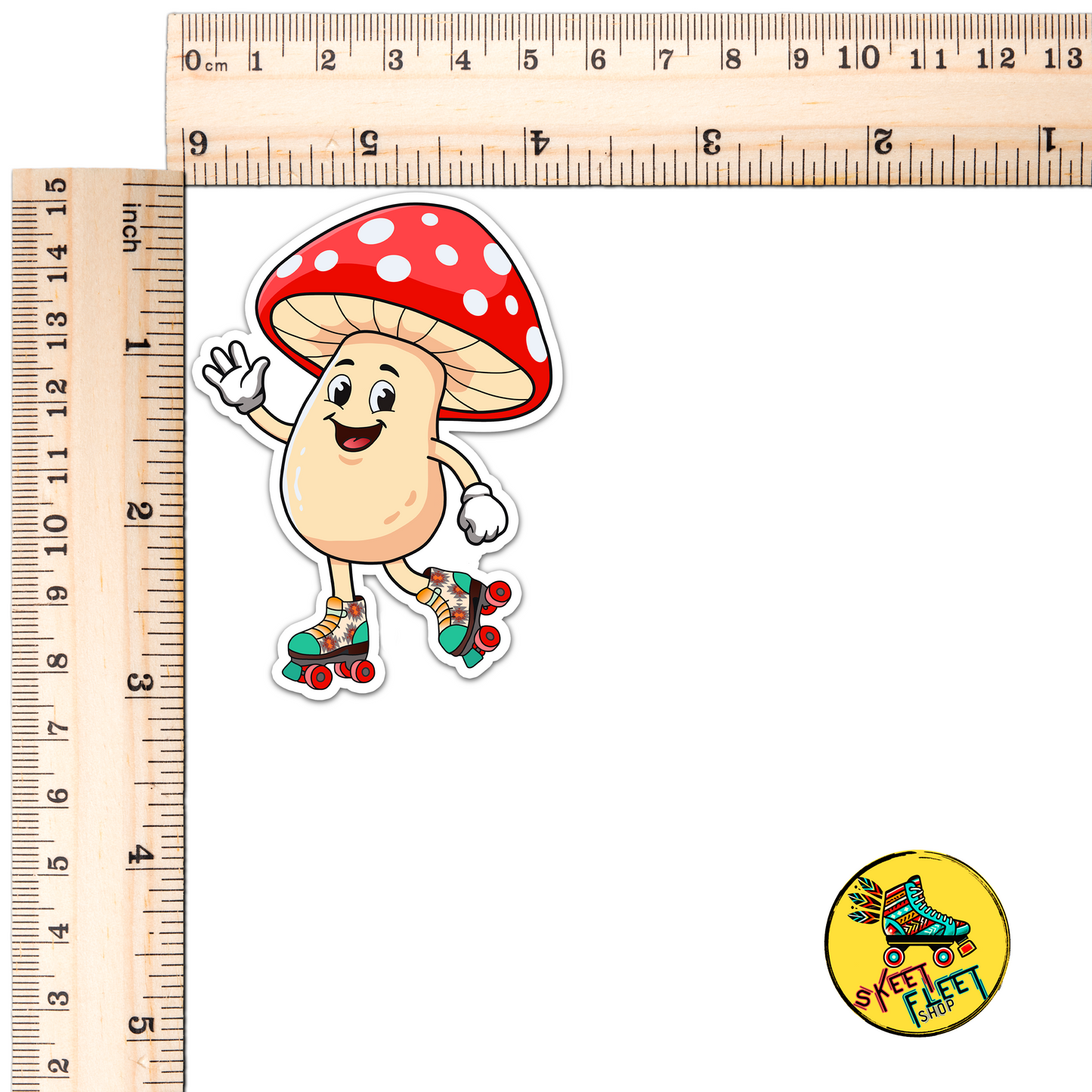 Cartoon mushroom sticker with a red cap and white spots, standing on roller skates, next to two rulers for scale.