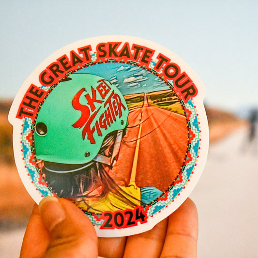 Sticker for 'The Great Skate Tour' held by a hand with a blurred background