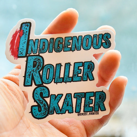 Hand holding a sticker with 'Indigenous Roller Skater' text against a blurred background