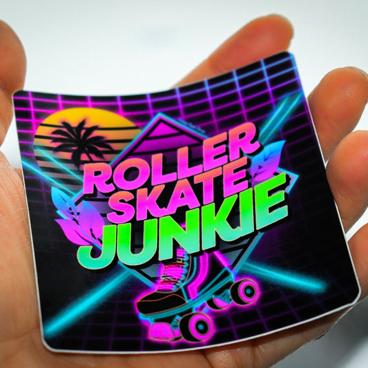 Neon sign with 'Roller Skates Junkie' text held in a hand against a blurred background