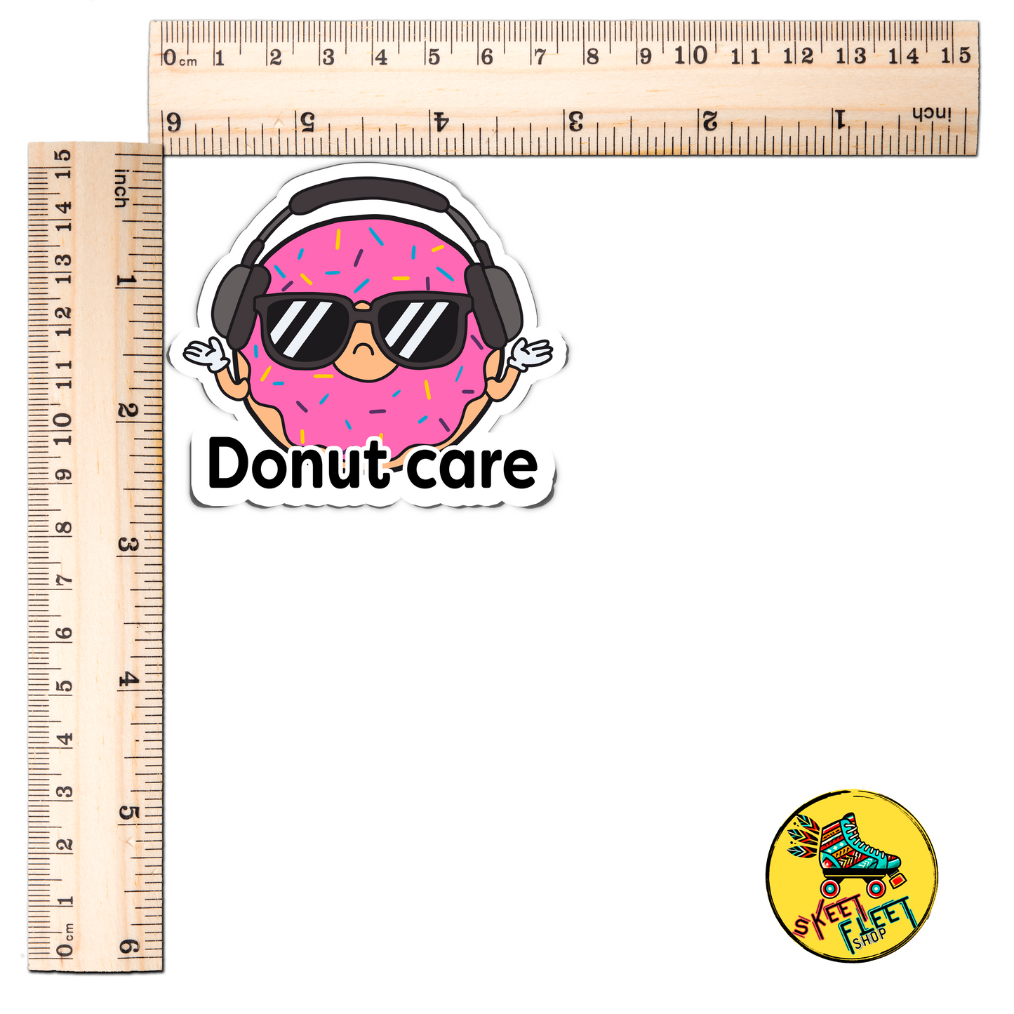 Sticker of a donut wearing sunglasses and headphones with 'Donut care' text, next to two rulers for scale.