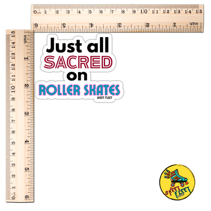 Sticker with text 'Just all sacred on Roller Skates' and a small round sticker with roller skates and text, next to two rulers for scale.